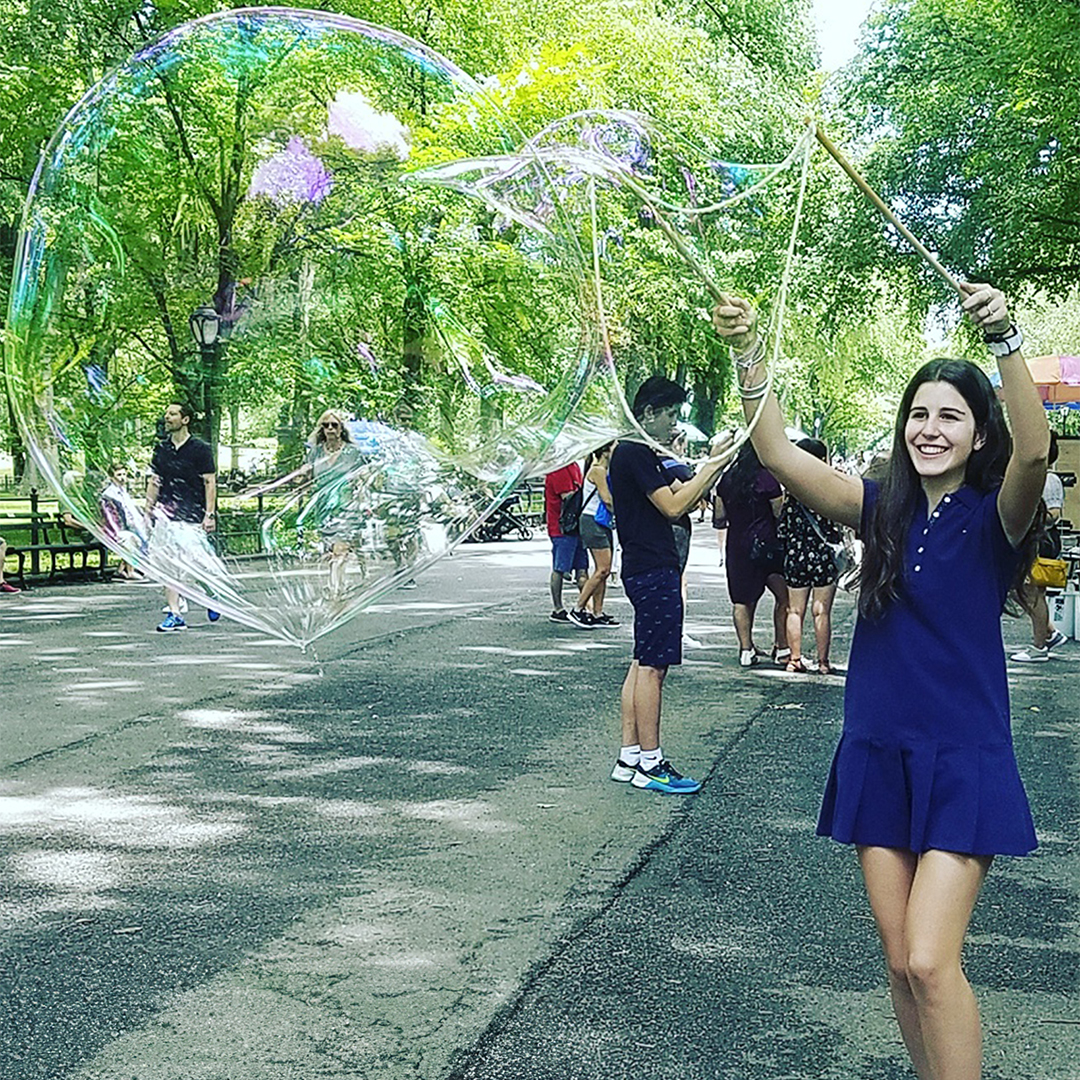 Giant BubbleStix bubble in a green park