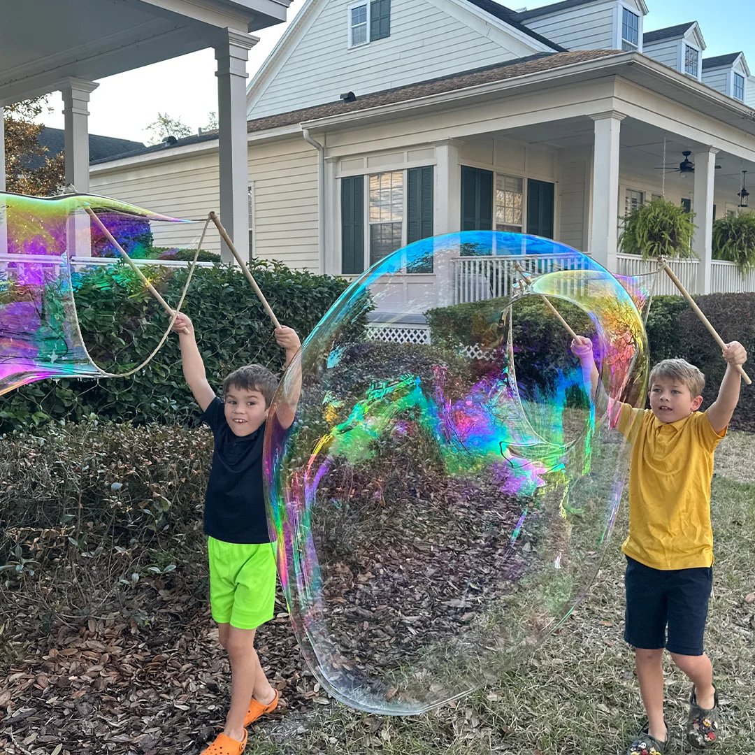 Children making giant bubbles together with BubbleStix